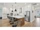 Stylish kitchen boasts a central island with seating, stainless appliances, and ample white cabinetry at 13460 Bergamont Cir, Tampa, FL 33618