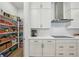 Well-organized walk-in pantry with ample shelving next to a bright, modern kitchen at 13460 Bergamont Cir, Tampa, FL 33618