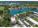 An aerial view showcasing a condo community nestled along a beautiful blue lake at 135 Nina Way # 35, Oldsmar, FL 34677