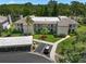 An aerial view of a condo building featuring visitor parking and lush landscaping at 135 Nina Way # 35, Oldsmar, FL 34677