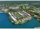 Aerial view of a waterfront condo complex featuring beautiful lake views and well-maintained grounds at 135 Nina Way # 35, Oldsmar, FL 34677