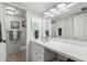Bathroom featuring a large mirror and sleek white countertops at 135 Nina Way # 35, Oldsmar, FL 34677