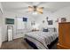 Bedroom featuring a patterned bedspread, ceiling fan, and light neutral carpeting at 135 Nina Way # 35, Oldsmar, FL 34677