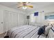 Bedroom featuring a patterned bedspread, ceiling fan, and light neutral carpeting at 135 Nina Way # 35, Oldsmar, FL 34677