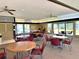 Community clubhouse interior with tables, chairs and a lounge area at 135 Nina Way # 35, Oldsmar, FL 34677