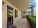An exterior hallway with a beige textured wall and a front door. Stairs going to the second level at 135 Nina Way # 35, Oldsmar, FL 34677
