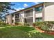 Exterior of home featuring manicured lawn and landscaping at 135 Nina Way # 35, Oldsmar, FL 34677