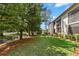 Exterior of home featuring manicured lawn, landscaping, and mature trees at 135 Nina Way # 35, Oldsmar, FL 34677