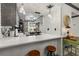 A bright and updated kitchen with a view of the dining area featuring white quartz countertops and neutral cabinets at 135 Nina Way # 35, Oldsmar, FL 34677