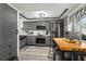 A bright and modern kitchen featuring gray cabinetry, stainless steel appliances, and a wooden island with seating at 135 Nina Way # 35, Oldsmar, FL 34677