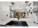 An open-concept kitchen view featuring gray cabinets, stylish decor, and a view into the living area at 135 Nina Way # 35, Oldsmar, FL 34677