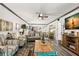Bright living room featuring coastal decor, ceiling fan, and gray wood flooring at 135 Nina Way # 35, Oldsmar, FL 34677