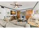 Living room featuring comfortable seating, barn door access to lanai, and ceiling fan at 135 Nina Way # 35, Oldsmar, FL 34677
