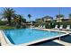 Community pool features lounge chairs for relaxing in the sun at 135 Nina Way # 35, Oldsmar, FL 34677