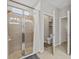 Bright bathroom featuring tile flooring, glass shower with natural light and adjoining toilet room at 13675 Paddington Way, Spring Hill, FL 34609