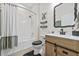 Cozy bathroom with shower-tub combo, and rustic wood vanity at 13675 Paddington Way, Spring Hill, FL 34609