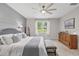 Bedroom with large window, ceiling fan, and neutral color palette at 13675 Paddington Way, Spring Hill, FL 34609