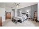 Bedroom featuring a gray accent wall, carpeted floor, ceiling fan and light wood dresser at 13675 Paddington Way, Spring Hill, FL 34609