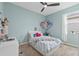 Bright bedroom with blue walls, carpet, and ceiling fan at 13675 Paddington Way, Spring Hill, FL 34609