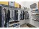 Walk-in closet with metal shelving, clothing, and accessories for organized storage at 13675 Paddington Way, Spring Hill, FL 34609