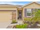 Charming home featuring a stone-accented facade and well-manicured landscaping at 13675 Paddington Way, Spring Hill, FL 34609