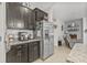 Well-equipped kitchen features granite countertops, stainless steel refrigerator, and espresso cabinetry at 13675 Paddington Way, Spring Hill, FL 34609