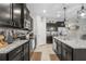 Modern kitchen featuring granite countertops, stainless steel appliances, and dark wood cabinetry at 13675 Paddington Way, Spring Hill, FL 34609
