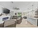 Bright living room features modern fireplace, neutral colors, tile flooring and sliding glass door to lanai at 13675 Paddington Way, Spring Hill, FL 34609