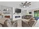 Cozy living room featuring a modern fireplace, comfortable seating, and a relaxing atmosphere at 13675 Paddington Way, Spring Hill, FL 34609