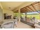 Covered patio area with wood ceiling, dining table and chairs, and serene backyard view at 13675 Paddington Way, Spring Hill, FL 34609