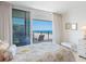 Bedroom with a comfortable bed, dresser, and balcony access overlooking the beautiful ocean at 1400 Gulf Blvd # 511, Clearwater Beach, FL 33767