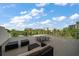 Spacious outdoor balcony with comfortable seating, panoramic views, and a blue sky with white clouds at 145 Belleview Blvd # 201, Belleair, FL 33756