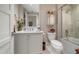 Well-lit bathroom features a single sink vanity and shower over tub at 145 Belleview Blvd # 201, Belleair, FL 33756