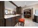 Bathroom featuring double vanity, dark wood cabinets and walk-in closet at 145 Belleview Blvd # 201, Belleair, FL 33756