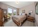 Comfortable bedroom with bright windows offering views of the outdoors at 145 Belleview Blvd # 201, Belleair, FL 33756