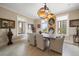 Dining room with rustic table, statement light fixture and large windows with views at 145 Belleview Blvd # 201, Belleair, FL 33756