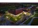 Exterior nighttime shot of clubhouse with palm trees and landscape lighting at 145 Belleview Blvd # 201, Belleair, FL 33756