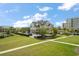 Exterior view of luxury apartments situated among lush green lawns and gardens at 145 Belleview Blvd # 201, Belleair, FL 33756