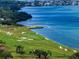 Picturesque golf course along the waterfront with sand traps and manicured greens at 145 Belleview Blvd # 201, Belleair, FL 33756