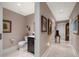 Hallway with attractive decor leading to half bathroom with vanity sink at 145 Belleview Blvd # 201, Belleair, FL 33756