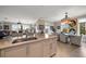 An open kitchen design with an island sink and seating area offering seamless flow to the dining and living area at 145 Belleview Blvd # 201, Belleair, FL 33756