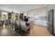 Modern kitchen with white cabinets, stainless steel appliances, bar stool seating, and an open floor plan at 145 Belleview Blvd # 201, Belleair, FL 33756
