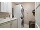 Functional laundry room featuring stacked washer/dryer and cabinet space at 145 Belleview Blvd # 201, Belleair, FL 33756