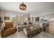 Comfortable living room with plush seating, decorative pillows, and access to balcony at 145 Belleview Blvd # 201, Belleair, FL 33756