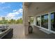 Spacious covered patio with seating and a view of lush landscaping at 145 Belleview Blvd # 201, Belleair, FL 33756