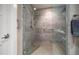 Modern bathroom shower featuring beautiful gray tile surround and glass door at 145 Belleview Blvd # 201, Belleair, FL 33756