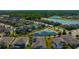 Wide aerial shot of the community showcasing homes with pond views and lush landscaping at 1476 Fort Cobb Ter, Wesley Chapel, FL 33543