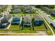 Neighborhood aerial view of homes with lush green lawns and proximity to a pond at 1476 Fort Cobb Ter, Wesley Chapel, FL 33543