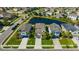 An aerial view of the neighborhood with a pond nearby at 1476 Fort Cobb Ter, Wesley Chapel, FL 33543