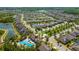Scenic aerial view of the neighborhood, showcasing lush landscaping, ponds, and community amenities at 1476 Fort Cobb Ter, Wesley Chapel, FL 33543